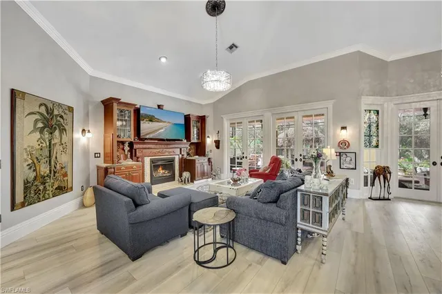 a living room with furniture a dining table and a fireplace