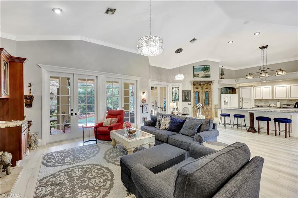 1904 Bethany Place Naples, FL 34109 - Photo 6 of 26 a living room with furniture a dining table and a fireplace