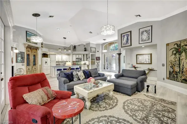 a large kitchen with cabinets and chairs