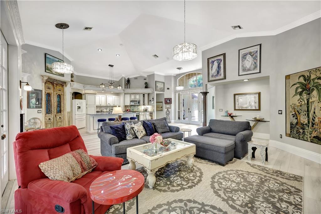 1904 Bethany Place Naples, FL 34109 - Photo 7 of 26 a living room with fireplace furniture and a chandelier