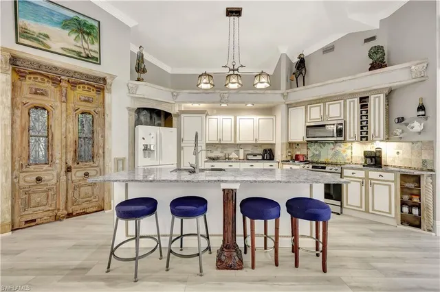 a dining room with furniture a chandelier and window