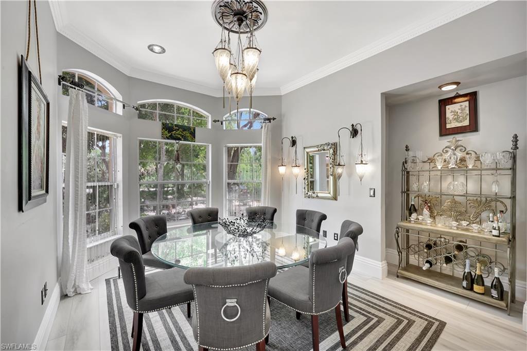1904 Bethany Place Naples, FL 34109 - Photo 9 of 26 a dining room with furniture a chandelier and window