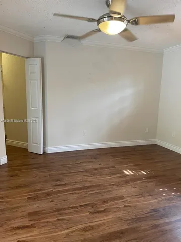 a view of a room with wooden floor