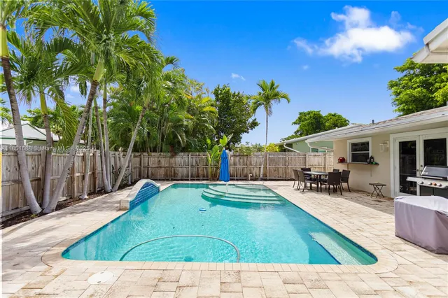 a swimming pool with outdoor seating and yard