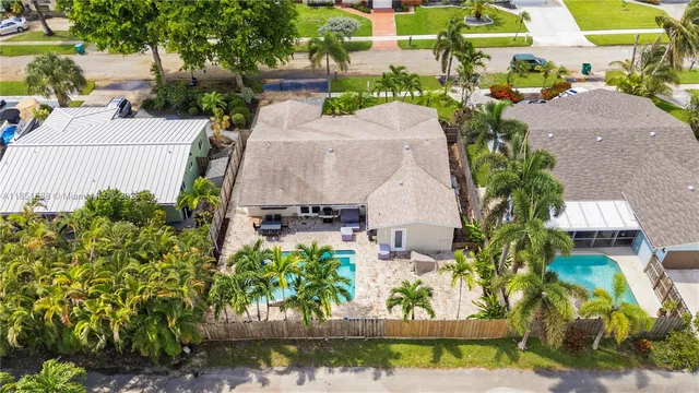 an aerial view of a house with a yard and lake view
