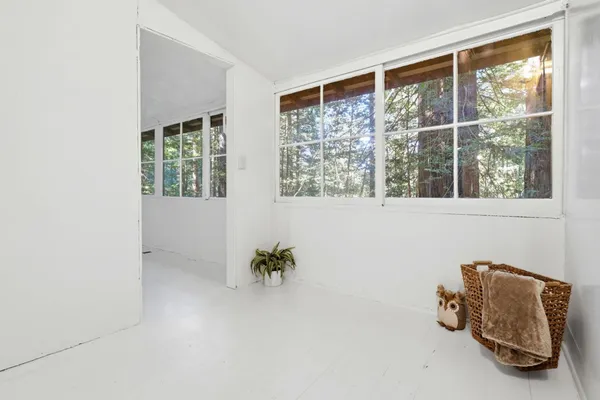 a view of room with furniture and windows