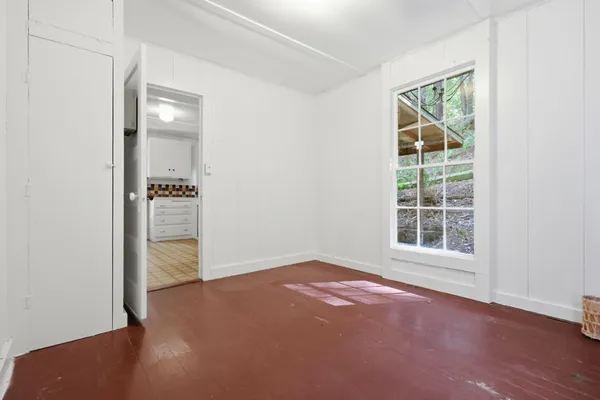 an empty room with windows and closet
