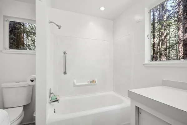 a white bath tub sitting next to a white toilet