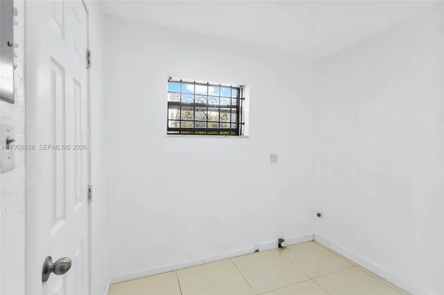 a view of storage and utility room with a window