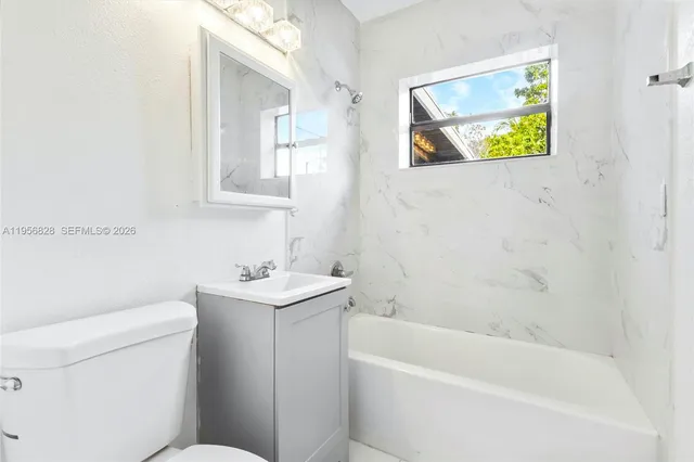 a bathroom with a sink a toilet and bathtub