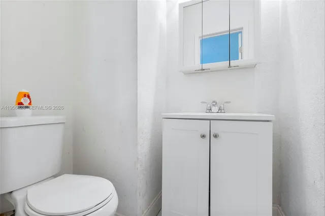a bathroom with a sink a toilet and mirror