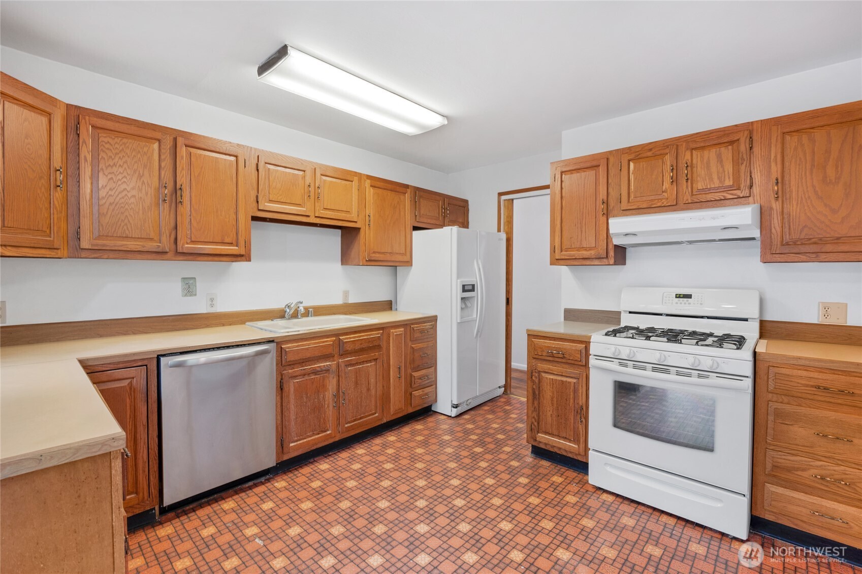 611 3rd Avenue North Edmonds, WA 98020 - Photo 12 of 28 a kitchen with a stove top oven sink and cabinets