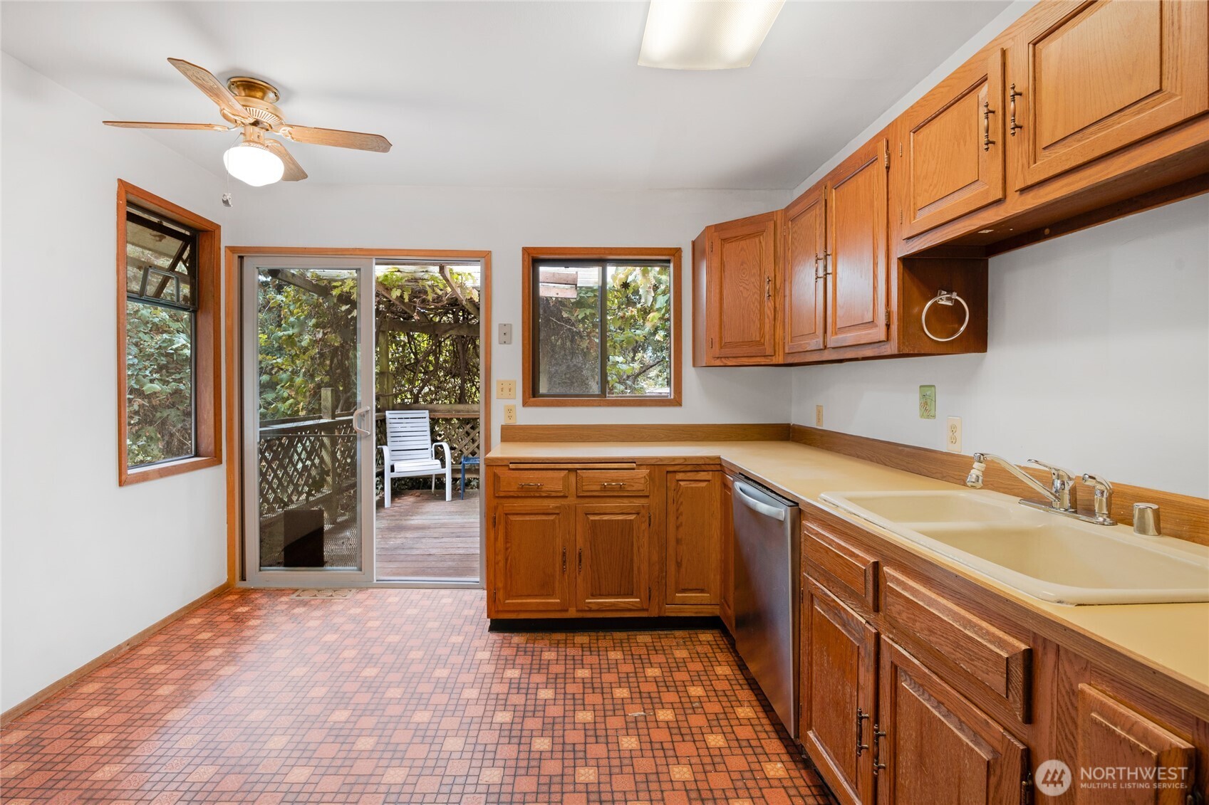 611 3rd Avenue North Edmonds, WA 98020 - Photo 13 of 28 a kitchen with stainless steel appliances granite countertop a refrigerator a sink dishwasher and wooden cabinets with wooden floor