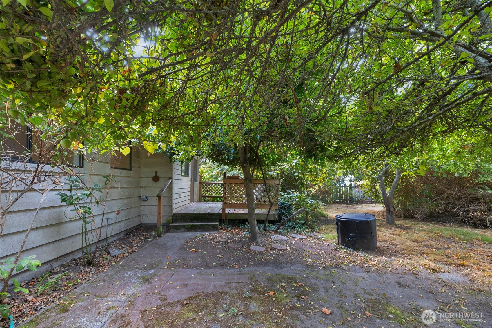 611 3rd Avenue North Edmonds, WA 98020 - Photo 22 of 28 a view of a backyard with large trees and wooden fence