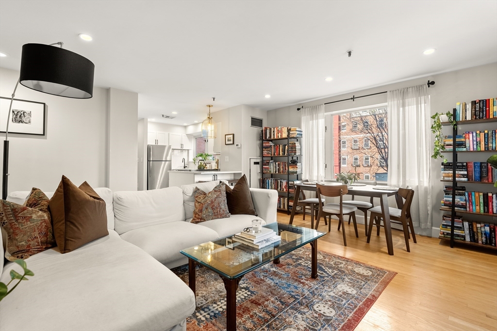 a living room with furniture and a book shelf