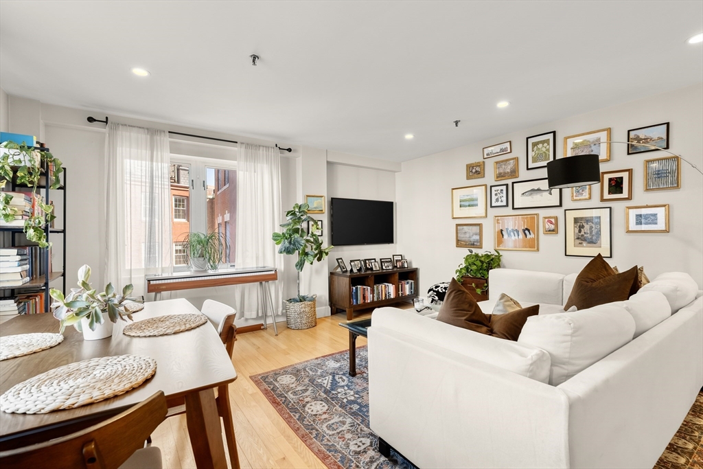 350 North Street, Unit 200 Boston, MA 02113 - Photo 2 of 22 a living room with furniture and a flat screen tv