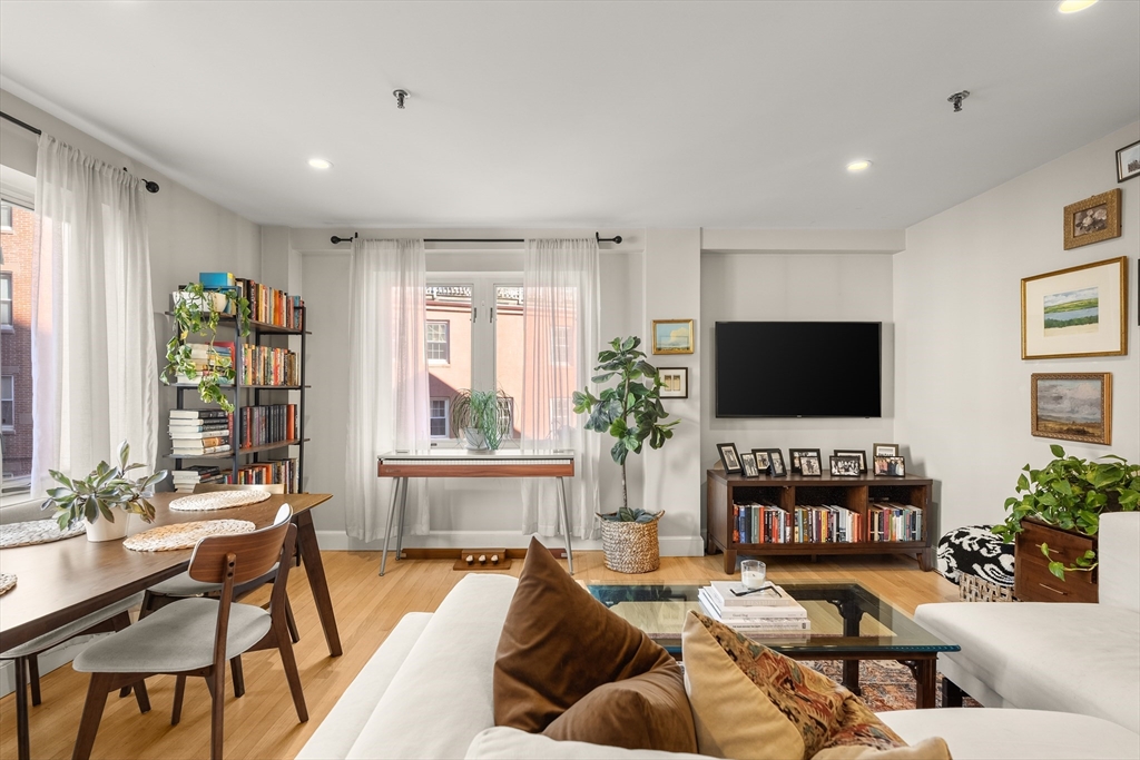 350 North Street, Unit 200 Boston, MA 02113 - Photo 5 of 22 a living room with fireplace furniture and a flat screen tv