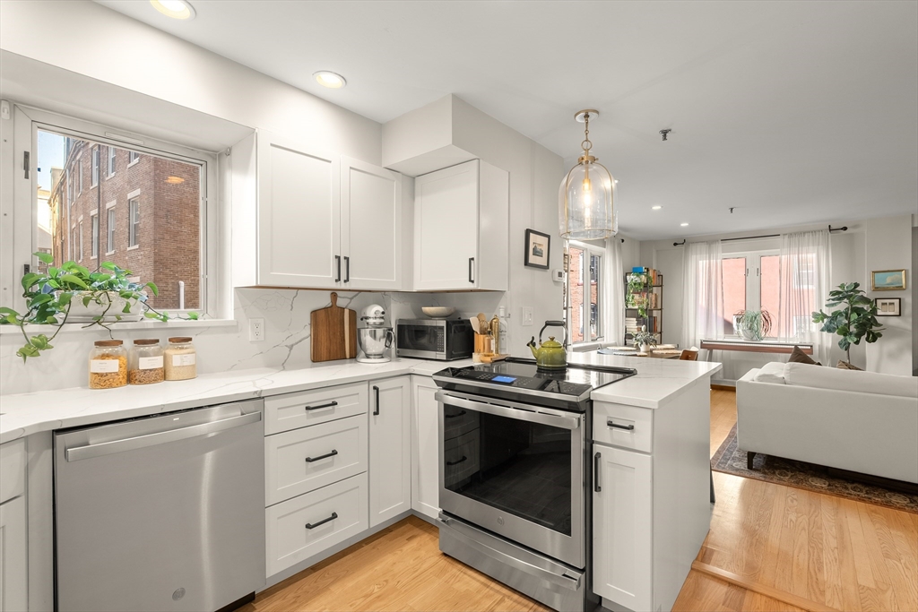 350 North Street, Unit 200 Boston, MA 02113 - Photo 9 of 22 a kitchen with a stove sink and cabinets