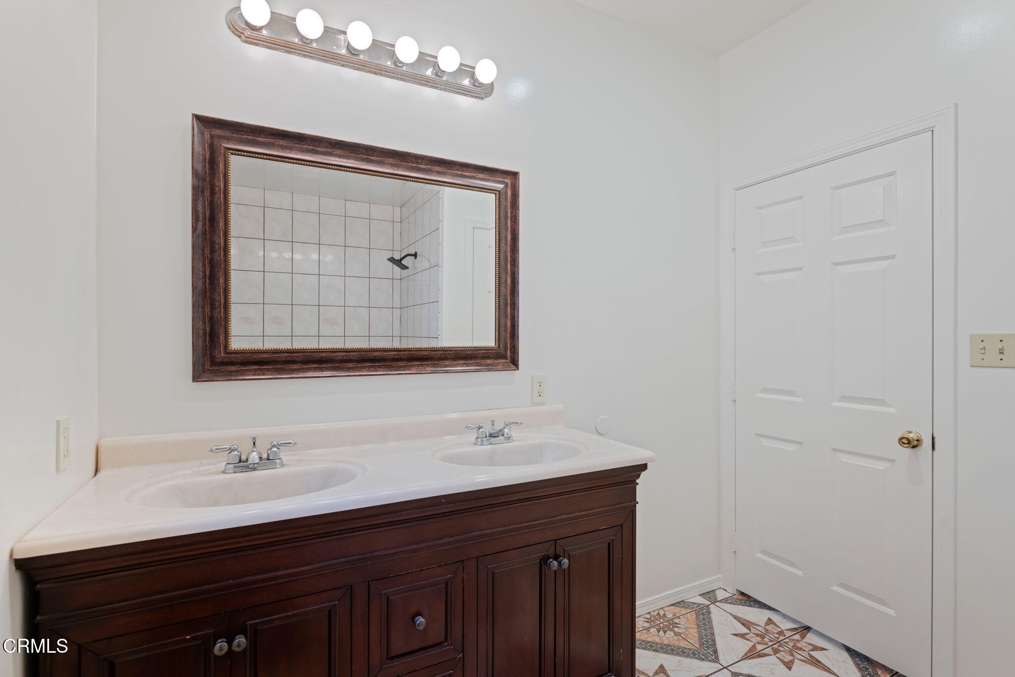 717 West Villanova Road Ojai, CA 93023 - Photo 17 of 33 a bathroom with a double vanity sink and a mirror