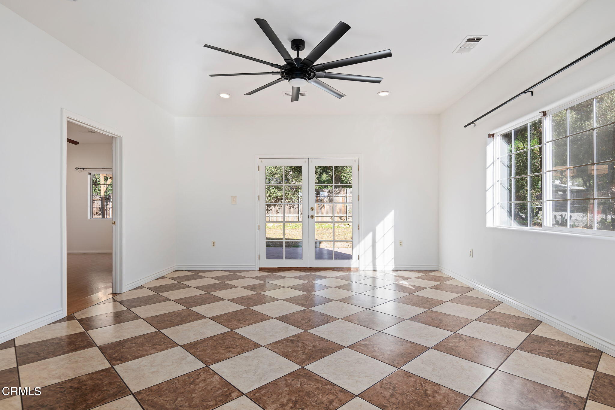 717 West Villanova Road Ojai, CA 93023 - Photo 10 of 33 a living room with a black white checkered floor with a gaming machine and a dining table