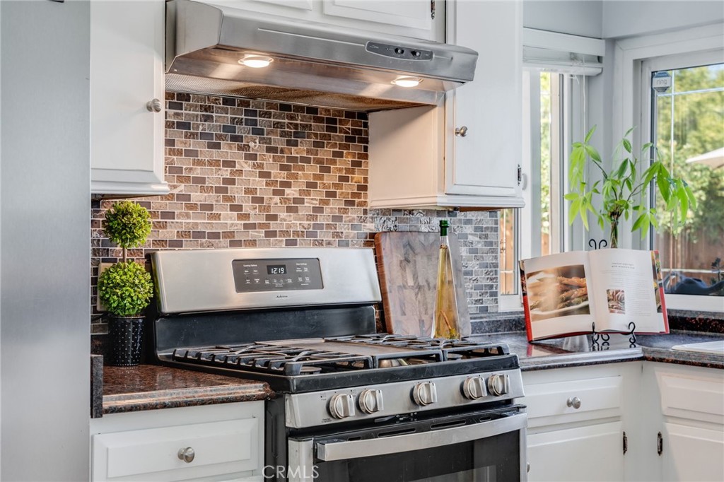 1935 Adobe Avenue Corona, CA 92882 - Photo 16 of 45 a stove top oven sitting inside of a kitchen