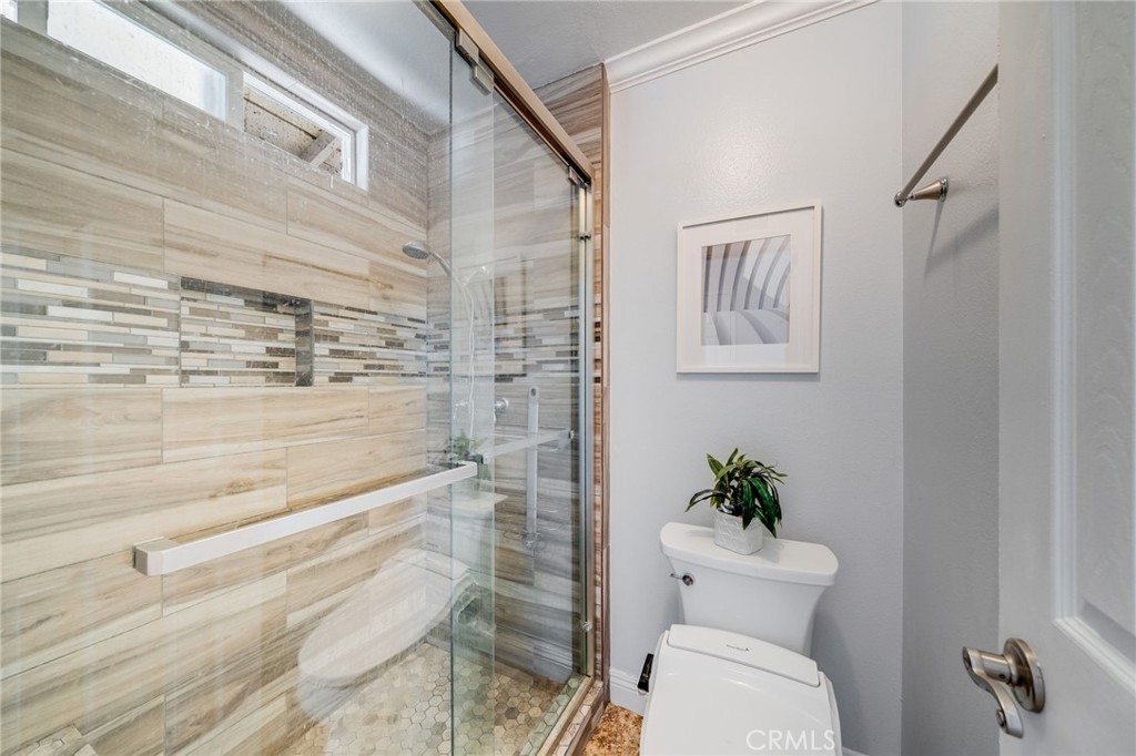 1935 Adobe Avenue Corona, CA 92882 - Photo 22 of 45 a bathroom with a toilet and a shower