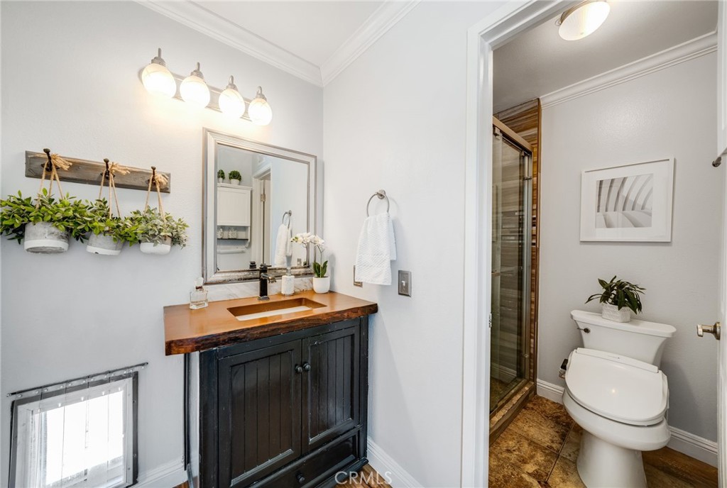 1935 Adobe Avenue Corona, CA 92882 - Photo 23 of 45 a bathroom with a granite countertop toilet a sink and a mirror