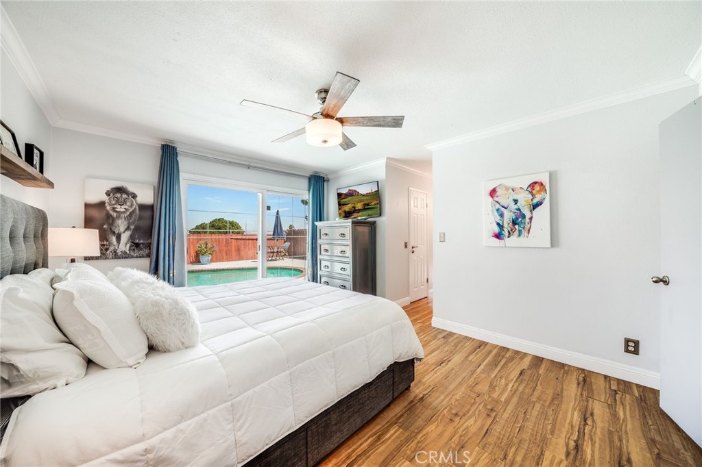 1935 Adobe Avenue Corona, CA 92882 - Photo 25 of 45 a spacious bedroom with a bed and a chandelier