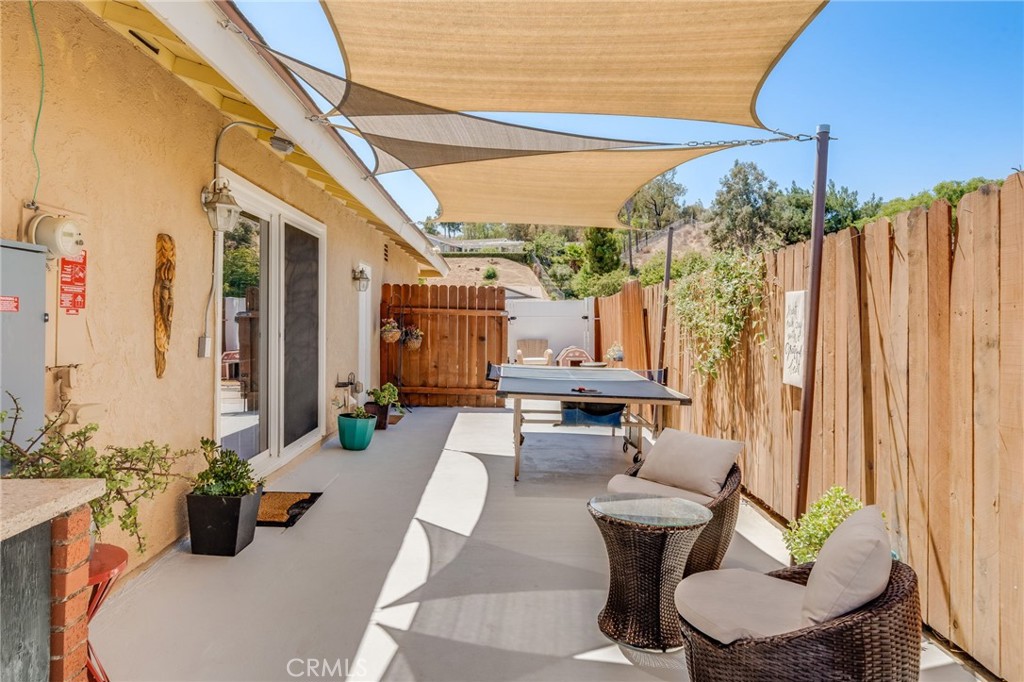 1935 Adobe Avenue Corona, CA 92882 - Photo 33 of 45 a view of a patio with couches chairs potted plants and a table and chairs