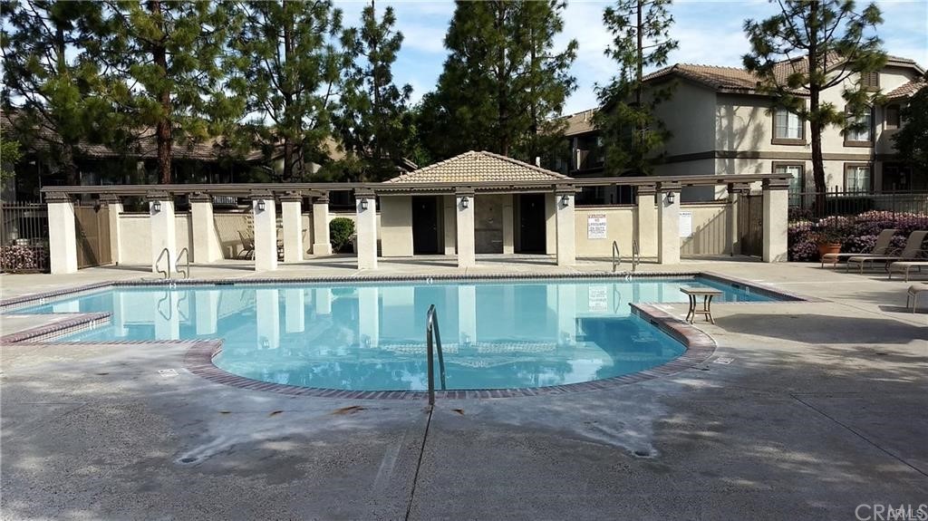 291 Chaumont Circle Lake Forest, CA 92610 - Photo 3 of 13 a view of a white house with a swimming pool
