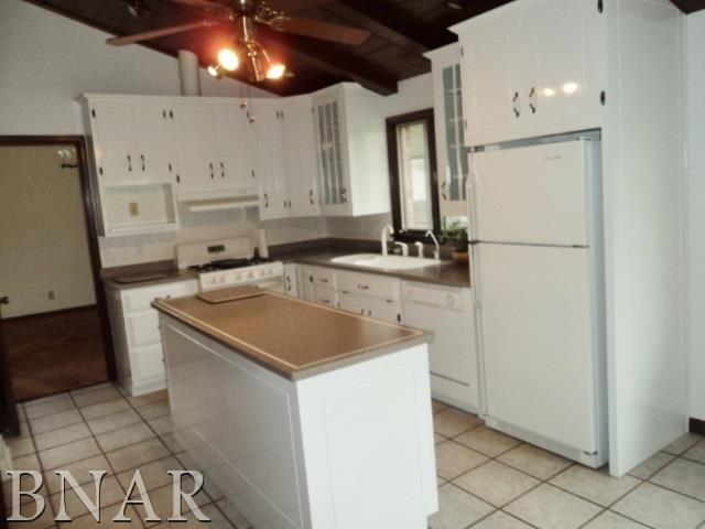 5801 Viking Road Clinton, IL 61727 - Photo 13 of 27 a utility room with cabinets washer and dryer