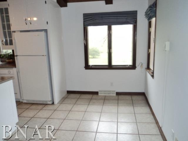 5801 Viking Road Clinton, IL 61727 - Photo 15 of 27 a view of a kitchen with a white cabinet and a refrigerator