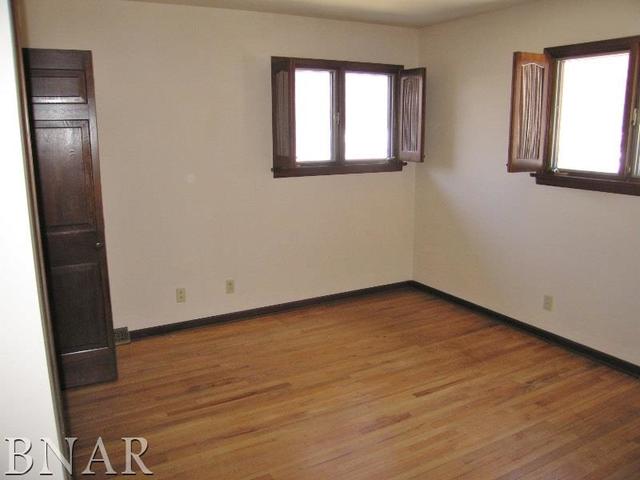 5801 Viking Road Clinton, IL 61727 - Photo 21 of 27 a view of an empty room with wooden floor and a window