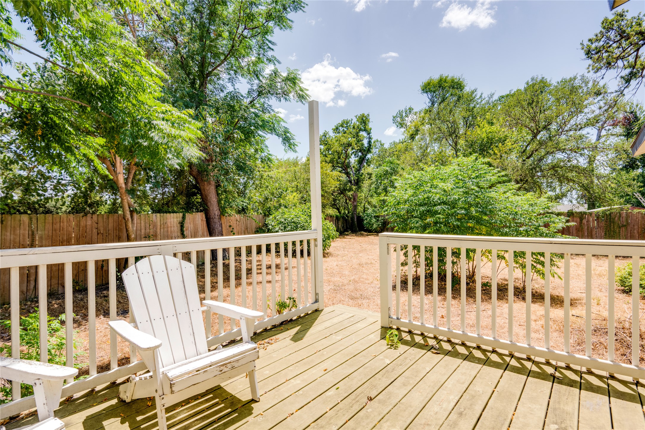1400 Marcus Place, Unit B Austin, TX 78721 - Photo 30 of 39 A welcoming deck extends to a generous, fenced yard, ideal for outdoor gatherings.