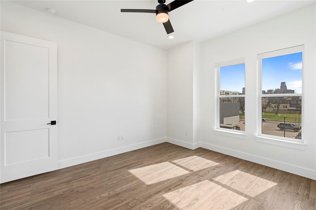 1804 Ripley Street, Unit 105 Dallas, TX 75204 - Photo 11 of 25 a view of an empty room with wooden floor and a window
