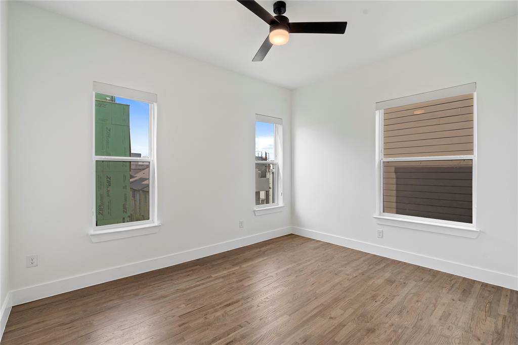 1804 Ripley Street, Unit 105 Dallas, TX 75204 - Photo 14 of 25 a view of an empty room with wooden floor and a window