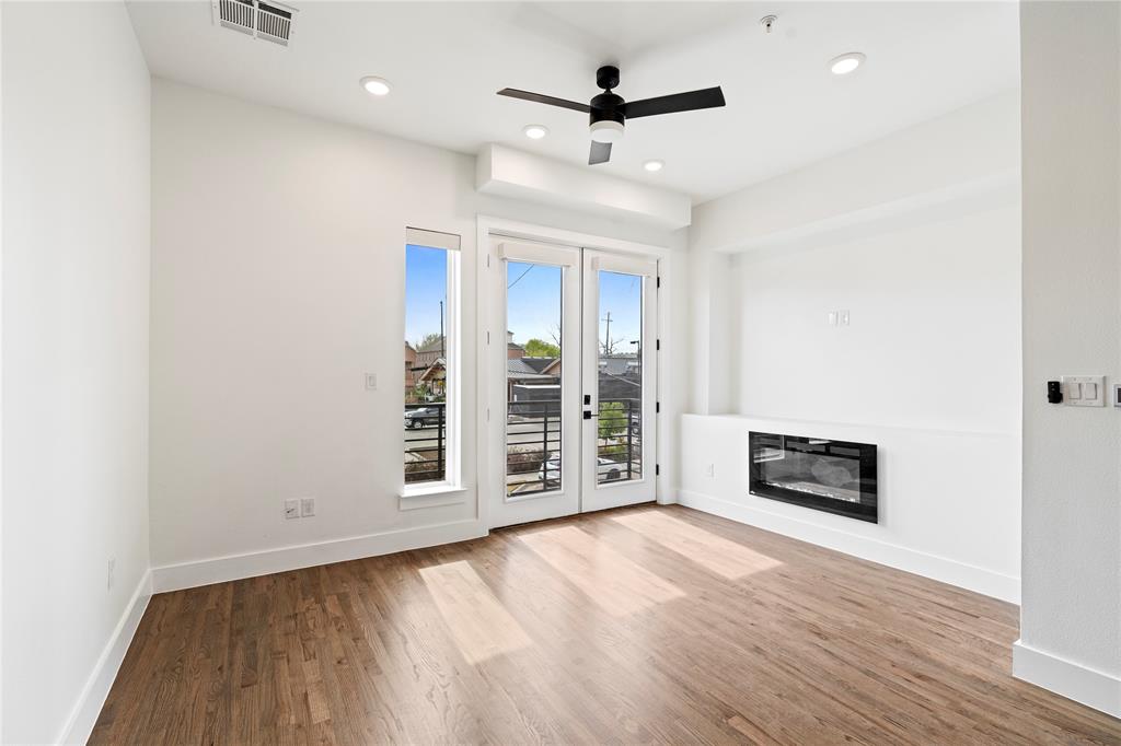 1804 Ripley Street, Unit 105 Dallas, TX 75204 - Photo 3 of 25 wooden floor in an empty room with a fireplace