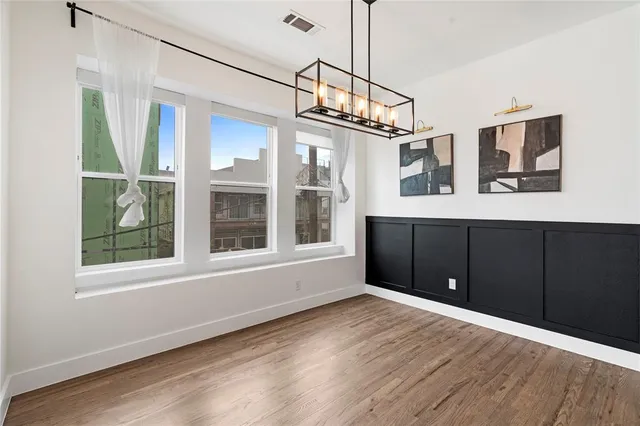 a view of a kitchen with wooden floor and windows
