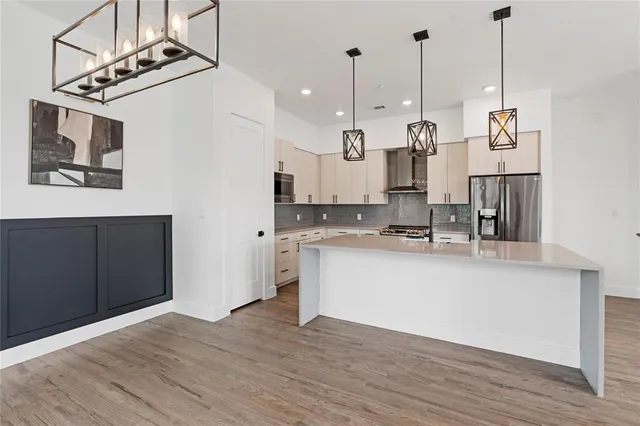 a view of kitchen with stainless steel appliances granite countertop cabinets and wooden floor
