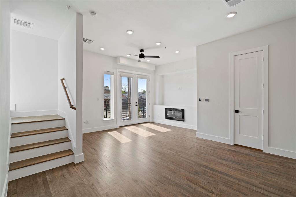 1804 Ripley Street, Unit 105 Dallas, TX 75204 - Photo 7 of 25 a view of an empty room with wooden floor and a ceiling fan
