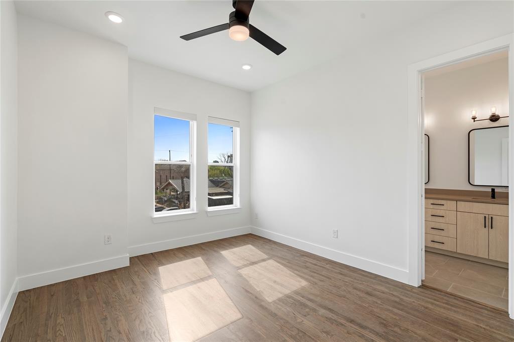 1804 Ripley Street, Unit 105 Dallas, TX 75204 - Photo 10 of 25 an empty room with wooden floor cabinet and windows