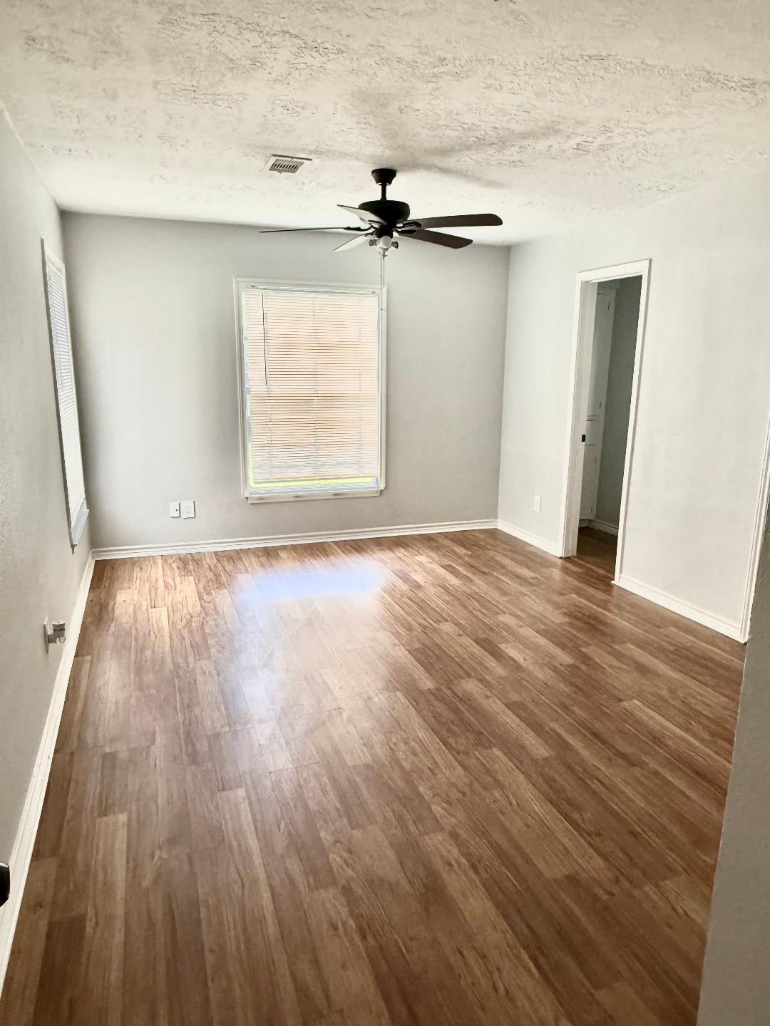 306 Rustic Drive Pasadena, TX 77502 - Photo 14 of 28 an empty room with wooden floor cabinet and windows
