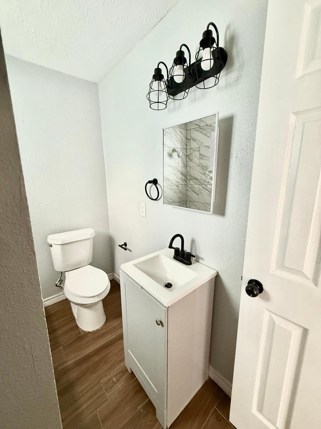 306 Rustic Drive Pasadena, TX 77502 - Photo 20 of 28 a bathroom with a toilet sink and mirror