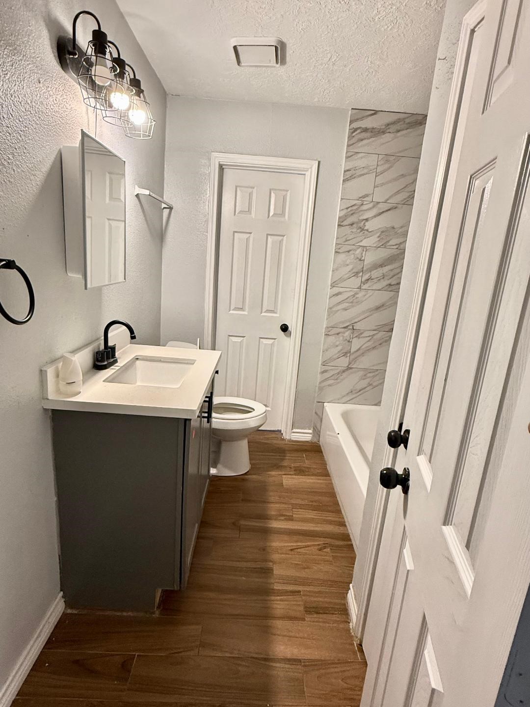 306 Rustic Drive Pasadena, TX 77502 - Photo 22 of 28 a bathroom with a sink a mirror and a shower