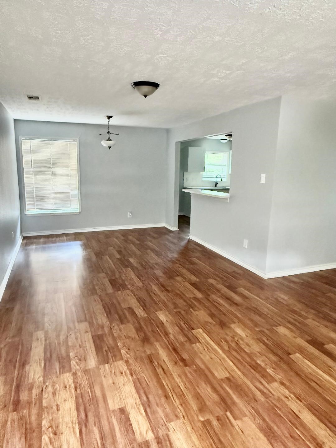 306 Rustic Drive Pasadena, TX 77502 - Photo 4 of 28 a view of an empty room with wooden floor and a window