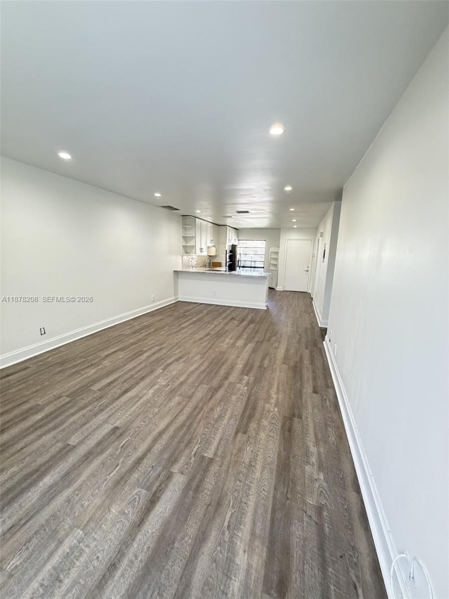 20927 Sedgewick Drive, Unit 20927 Boca Raton, FL 33433 - Photo 11 of 23 an empty room with wooden floor and windows