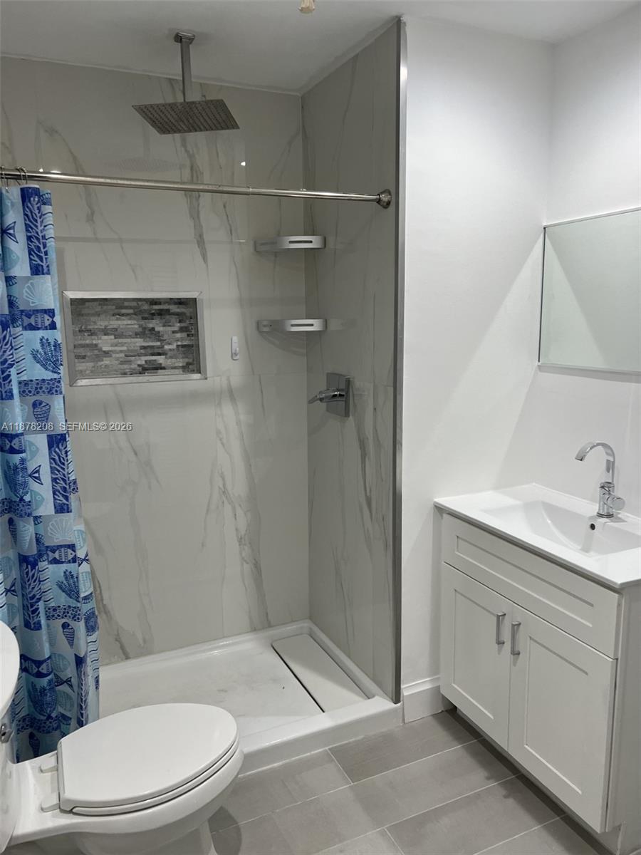 20927 Sedgewick Drive, Unit 20927 Boca Raton, FL 33433 - Photo 13 of 23 a bathroom with a sink a toilet and shower