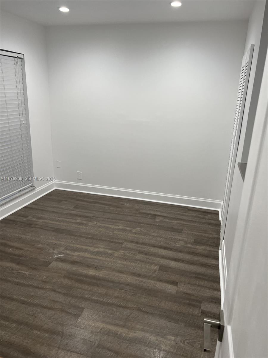 20927 Sedgewick Drive, Unit 20927 Boca Raton, FL 33433 - Photo 17 of 23 en empty room with wooden floor