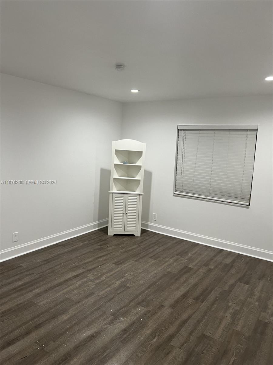 20927 Sedgewick Drive, Unit 20927 Boca Raton, FL 33433 - Photo 19 of 23 a view of an empty room with wooden floor and a window