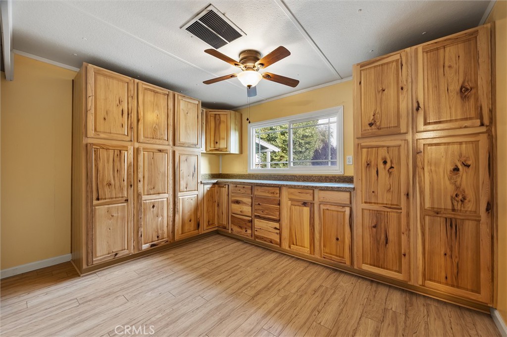 30751 Sharp Shafter, CA 93263 - Photo 37 of 73 a view of a kitchen with furniture wooden floor ceiling fan and windows